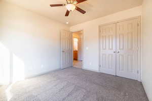 Unfurnished bedroom featuring a closet, ceiling fan, and carpet