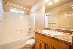 Full bathroom featuring shower / bath combination, vanity, and toilet