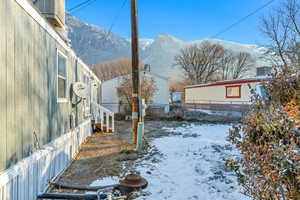 Snowy yard featuring a mountain view