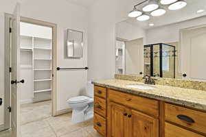 Master Bathroom featuring vanity, tile patterned floors, toilet, and walk in shower