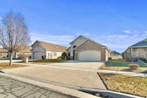 View of front of house with a garage and a front yard