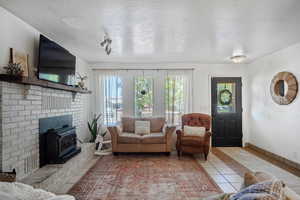 Living room featuring light tile patterned floors and a textured ceiling