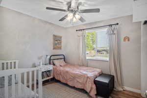 Bedroom with light hardwood / wood-style flooring and ceiling fan