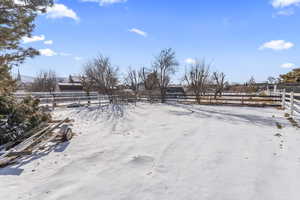 Rural view of maintained backyard, could be used for horses or gardening.