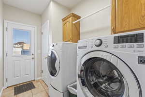 "Mud room" laundry area with coat closet and entrance from side exterior door.