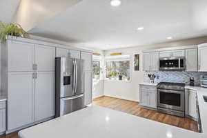 Remodeled kitchen, appliances with stainless steel finishes, lots of storage, and mountain views from corner window.