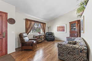 Front sitting room featuring vaulted ceiling