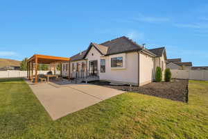 Back of house featuring a patio, an outdoor hangout area, and a yard