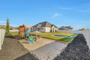 View of play area featuring a yard and a trampoline