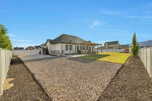 Rear view of property featuring a yard, a playground, and a patio area