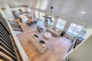 Living room with lofted ceiling and light wood-type flooring