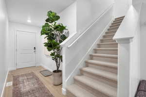 Foyer entrance wood-style floors and upgraded carpet and pad from Carpets America