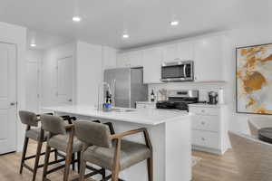 Kitchen finished with quartz countertops, stainless steel appliances, modern cabinetry with hardware, and pantry