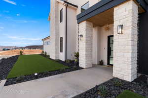 View of property exterior with a mountain view and a lawn