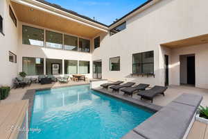 View of pool with an outdoor living space and a patio area