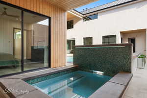 View of pool with an in ground hot tub