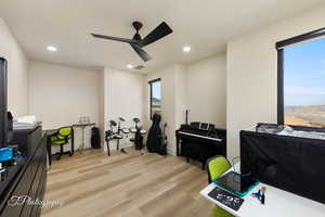 Misc room with ceiling fan and light wood-type flooring