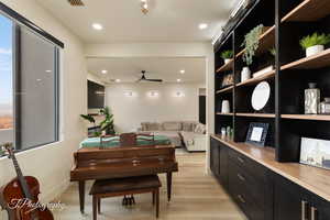 Miscellaneous room with light hardwood / wood-style flooring and ceiling fan