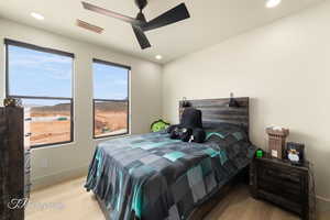 Bedroom featuring ceiling fan and light hardwood / wood-style flooring