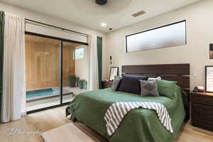 Bedroom with access to exterior and light hardwood / wood-style floors