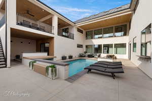 View of pool featuring an outdoor hangout area, a patio area, and ceiling fan