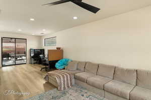 Living room featuring ceiling fan and light wood-type flooring