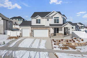 View of front of house with a garage and covered porch