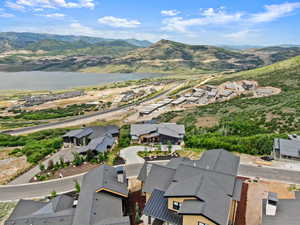 Drone / aerial view featuring a water and mountain view