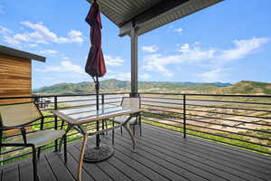 Wooden terrace featuring a mountain view