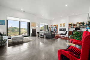 Living room with concrete flooring and a mountain view