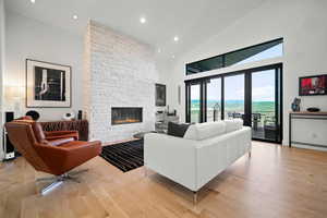 Living room featuring a mountain view, high vaulted ceiling, a fireplace, and light hardwood / wood-style floors