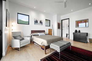 Bedroom with light hardwood / wood-style floors and ceiling fan