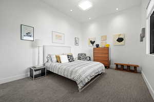 Bedroom featuring dark carpet