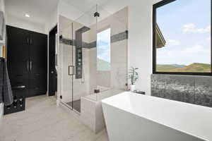 Bathroom featuring plus walk in shower and a mountain view