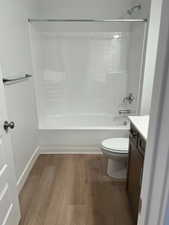 bathroom 2 Full bathroom featuring vanity, hardwood / wood-style flooring, bathtub / shower combination, and toilet