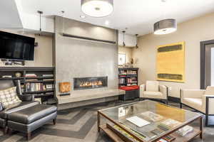 Living room featuring dark parquet flooring and a fireplace