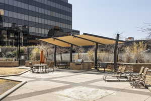 View of property's community with an outdoor kitchen and a patio