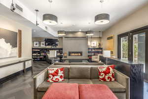 Living room with a large fireplace and dark parquet flooring