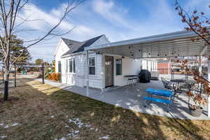 Rear view of house with central AC and a patio area