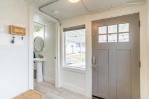 Doorway to outside featuring light tile patterned floors