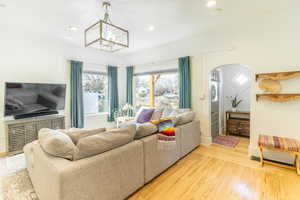 Living room featuring hardwood / wood-style floors and a notable chandelier