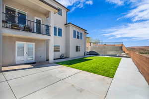 Back of house with a patio, a yard, and french doors