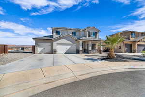 View of front of property with a garage and solar panels