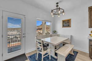 Dining room with an inviting chandelier and light hardwood / wood-style flooring