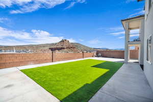 View of yard with a mountain view and a patio area