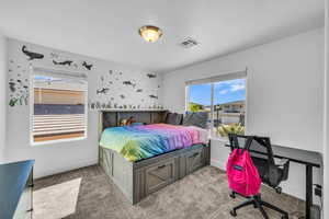 Bedroom featuring light colored carpet