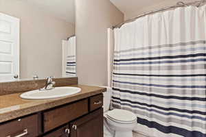 Bathroom featuring vanity and toilet