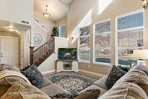 Living room featuring hardwood / wood-style floors and high vaulted ceiling