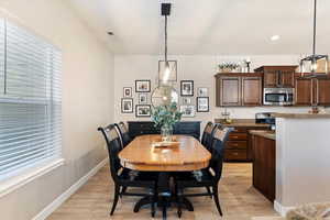 Dining area with light wood-type flooring