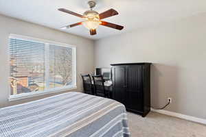 Bedroom featuring light carpet and ceiling fan